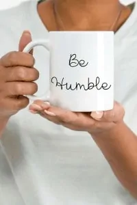 photo of woman holding mug titled 'be humble'